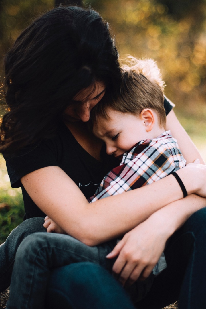 Une mère tient son fils triste dans ses bras