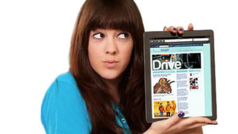 A teen girl holding an iPad showing the Vertical Thought website.